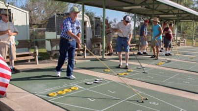 senior friends playing Shuffleboard