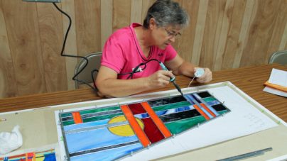 woman making stained-glass art